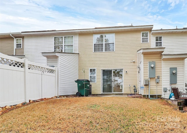 rear view of property featuring a yard