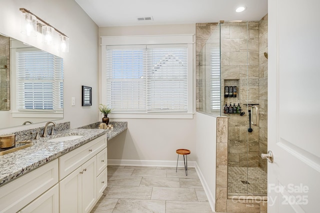 bathroom with vanity and a shower with shower door