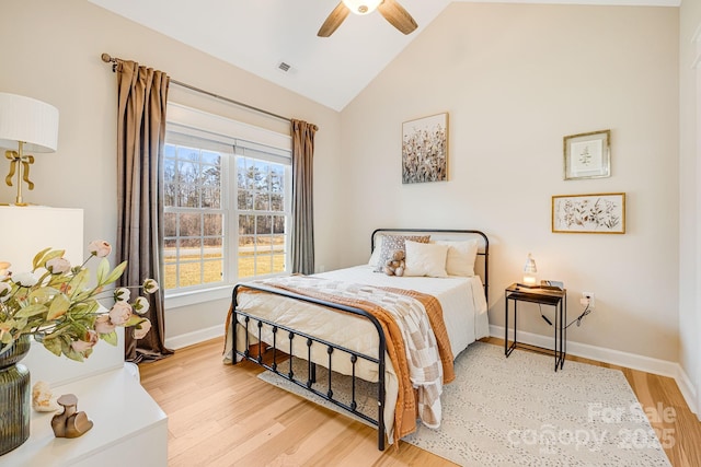 bedroom with ceiling fan, lofted ceiling, and light wood-type flooring