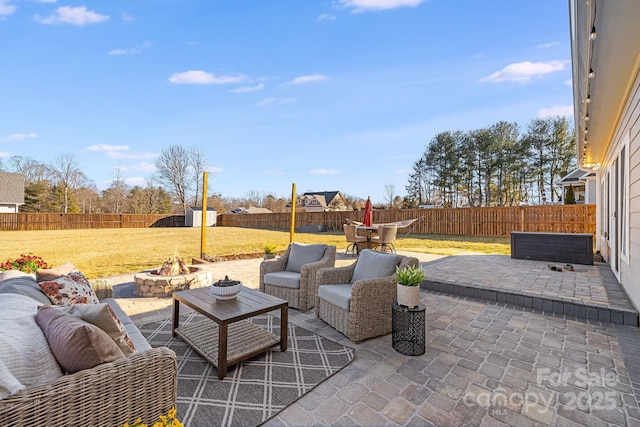 view of patio featuring an outdoor living space with a fire pit