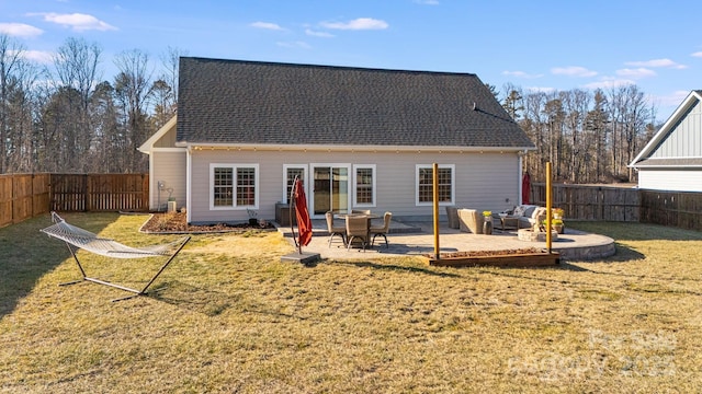 back of house with a patio area and a lawn