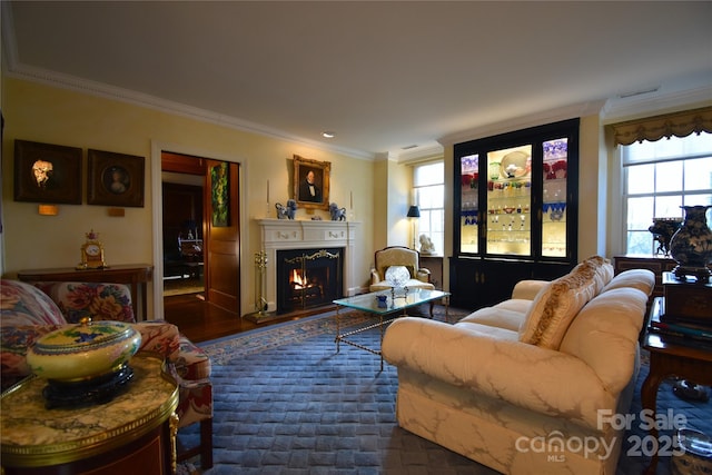 living room with ornamental molding, visible vents, a lit fireplace, and dark wood-style floors