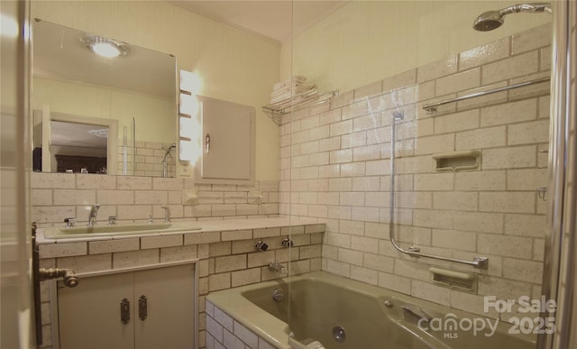 full bathroom with tiled shower / bath combo, vanity, and decorative backsplash