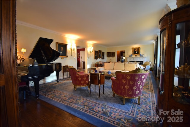 living room featuring ornamental molding, a fireplace, baseboards, and wood finished floors