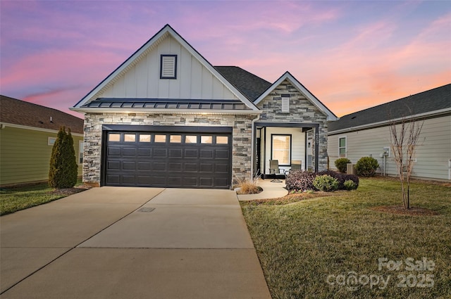 view of front of property with a garage and a yard