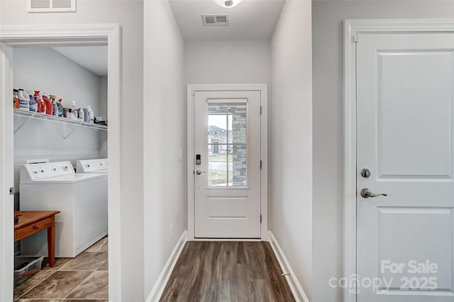 doorway to outside with separate washer and dryer