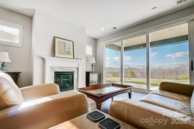 living room featuring a high end fireplace