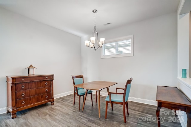 dining room featuring an inviting chandelier and hardwood / wood-style floors