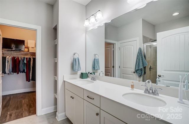 bathroom featuring vanity, tile patterned floors, and a shower with door