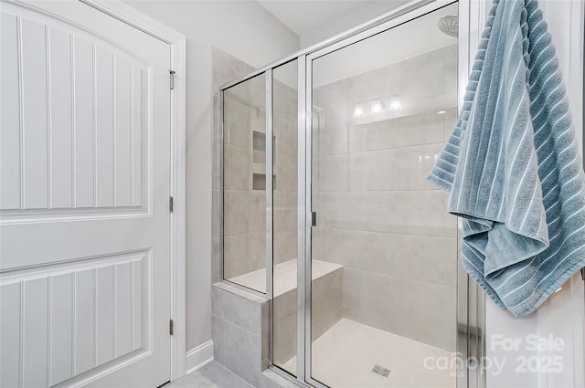 bathroom featuring a shower with door