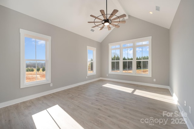 interior space with light hardwood / wood-style flooring, beam ceiling, a wealth of natural light, and ceiling fan