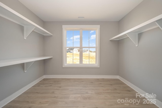 walk in closet featuring light hardwood / wood-style floors