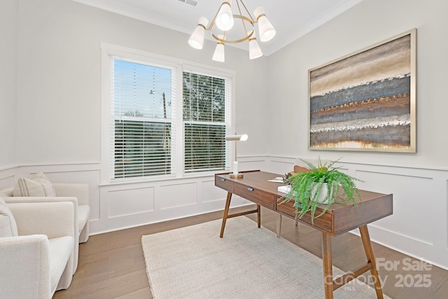 office space featuring hardwood / wood-style flooring, crown molding, and an inviting chandelier