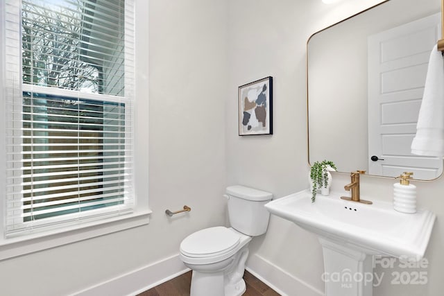 bathroom featuring hardwood / wood-style floors, a wealth of natural light, and toilet