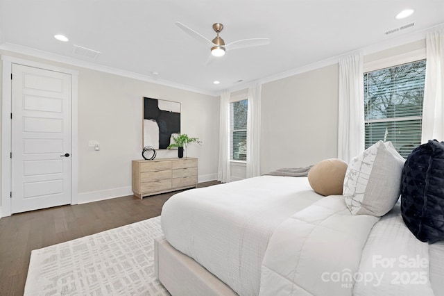 bedroom with dark hardwood / wood-style flooring, crown molding, and ceiling fan