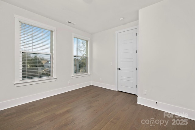 empty room featuring dark hardwood / wood-style floors