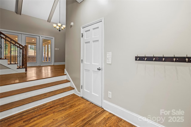 foyer featuring a notable chandelier, wood-type flooring, and french doors