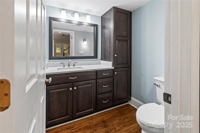 bathroom with vanity, hardwood / wood-style floors, and toilet