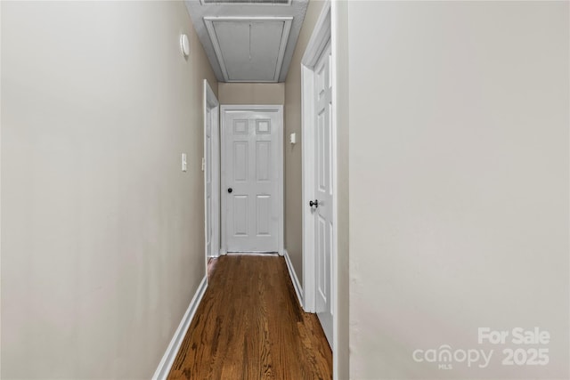 corridor with dark hardwood / wood-style flooring