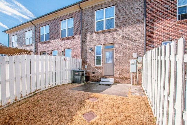 rear view of property with a patio area and central air condition unit