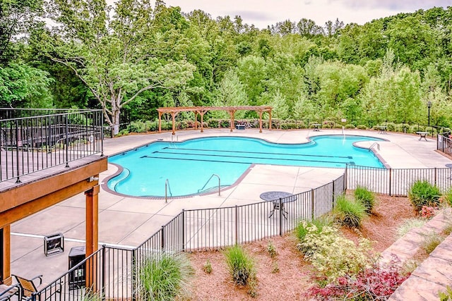 view of pool with a pergola and a patio area