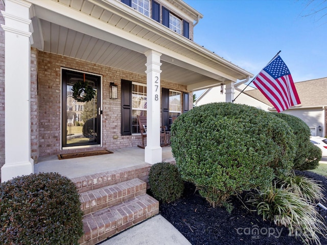 entrance to property featuring a porch