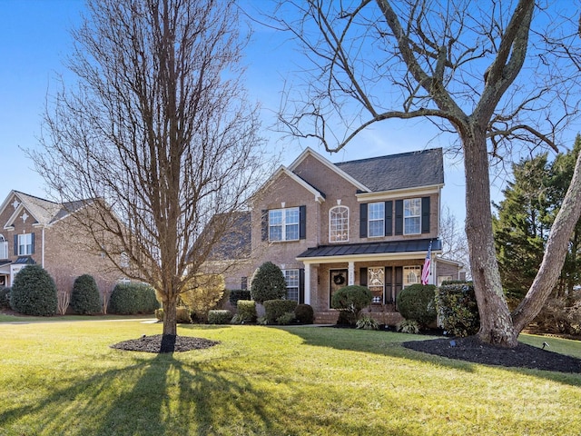 colonial home featuring covered porch and a front lawn