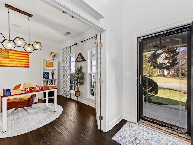 foyer featuring dark hardwood / wood-style flooring and ornamental molding