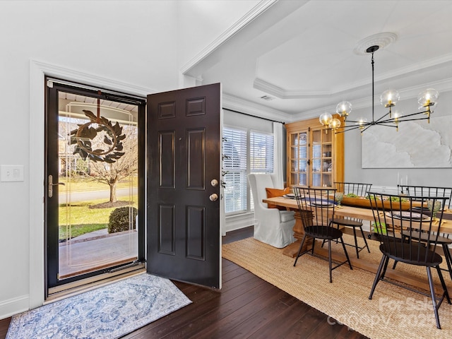 entryway featuring ornamental molding, dark hardwood / wood-style floors, and a tray ceiling