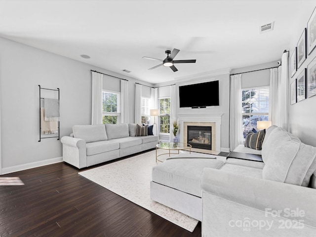 living room with ceiling fan, a healthy amount of sunlight, and dark hardwood / wood-style flooring