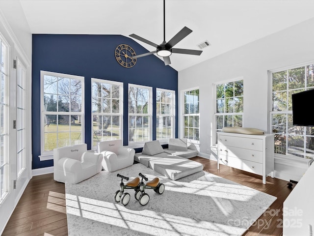 living room with ceiling fan, dark hardwood / wood-style flooring, and vaulted ceiling