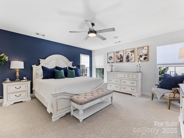 bedroom with light carpet and ceiling fan