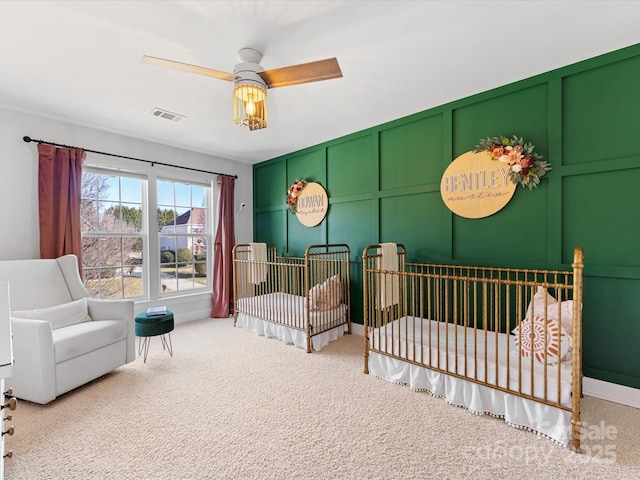 carpeted bedroom with a nursery area