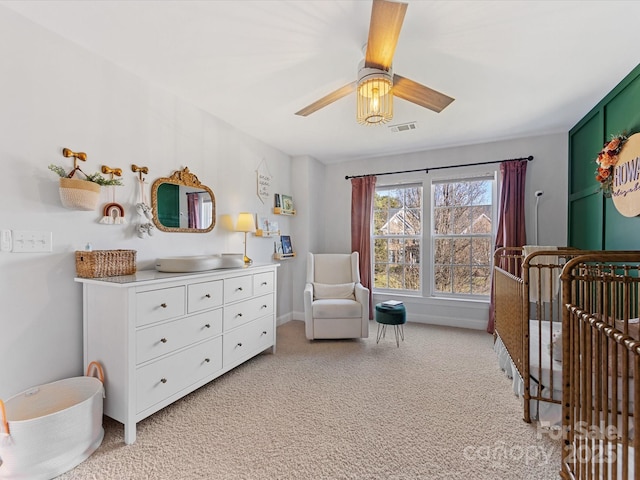 bedroom with ceiling fan and light carpet