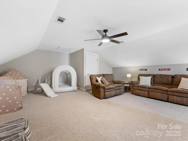 living room featuring ceiling fan, lofted ceiling, and carpet flooring