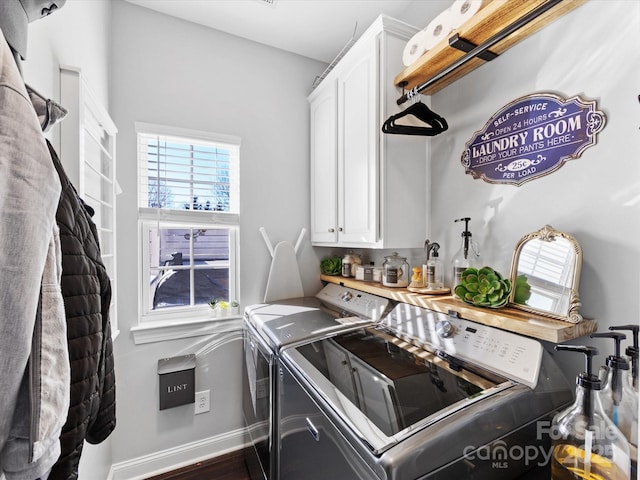 laundry room featuring cabinets and washing machine and dryer