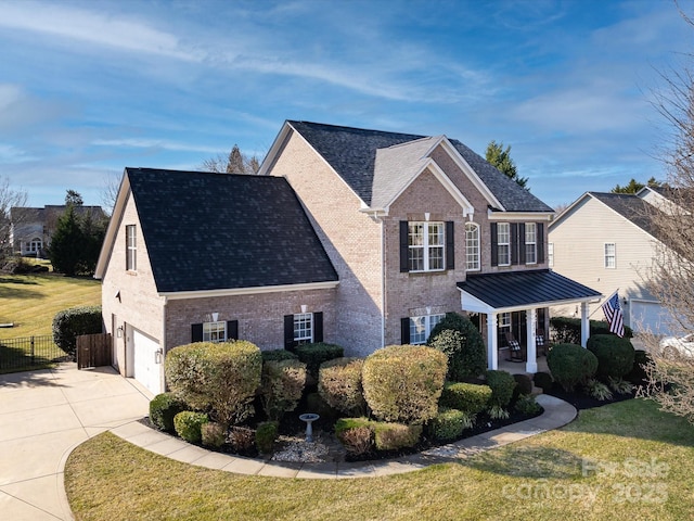 view of front of home featuring a garage, a front lawn, and a porch