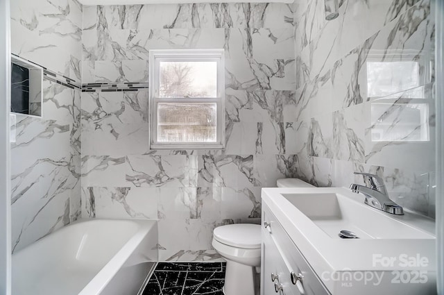 full bathroom with shower / tub combination, vanity, toilet, and tile walls