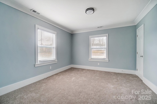 carpeted empty room featuring ornamental molding