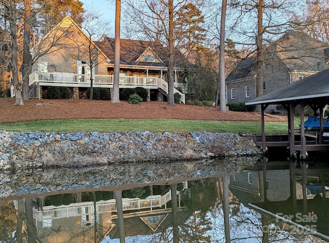 dock area with a water view and a yard