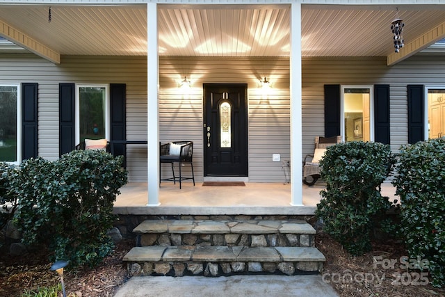 doorway to property featuring covered porch