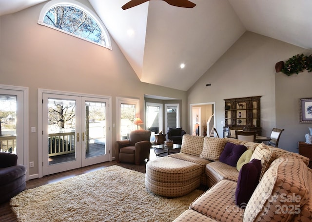 living room featuring ceiling fan, dark hardwood / wood-style floors, high vaulted ceiling, and french doors