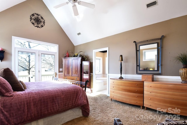 bedroom featuring ensuite bath, high vaulted ceiling, carpet floors, ceiling fan, and multiple windows