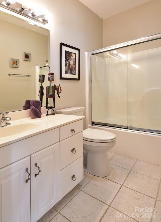 full bathroom with enclosed tub / shower combo, vanity, toilet, and tile patterned flooring