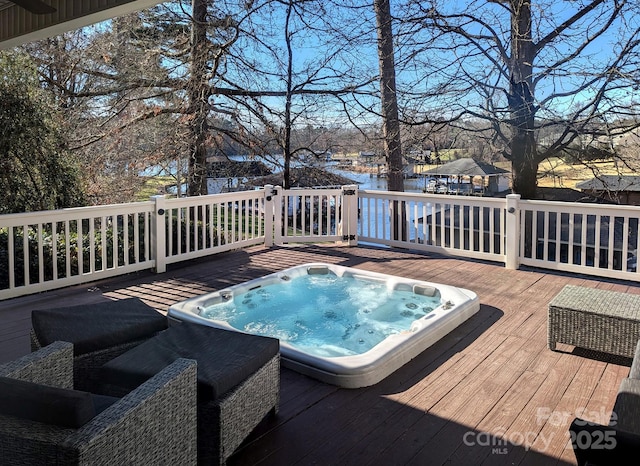 view of swimming pool with a deck with water view