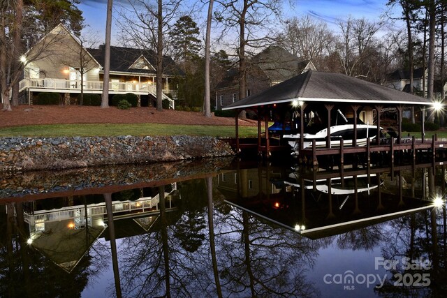 view of dock featuring a water view and a lawn