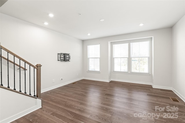 spare room featuring dark hardwood / wood-style flooring