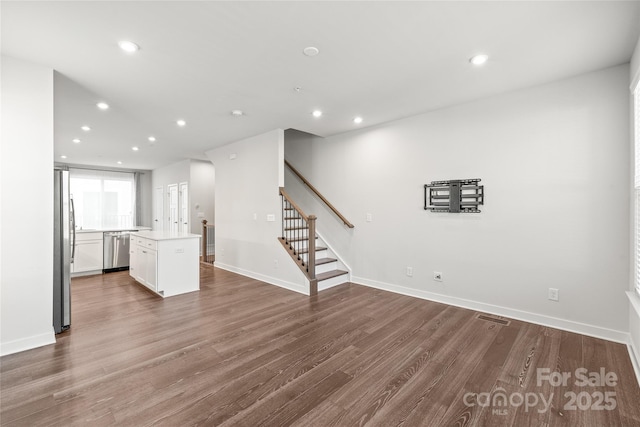 unfurnished living room with wood-type flooring