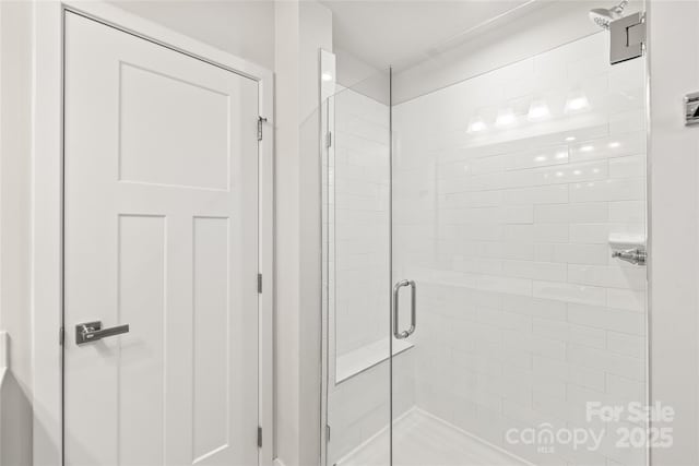 bathroom with a shower with shower door