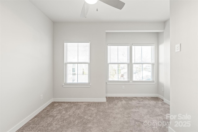 empty room featuring ceiling fan and light colored carpet